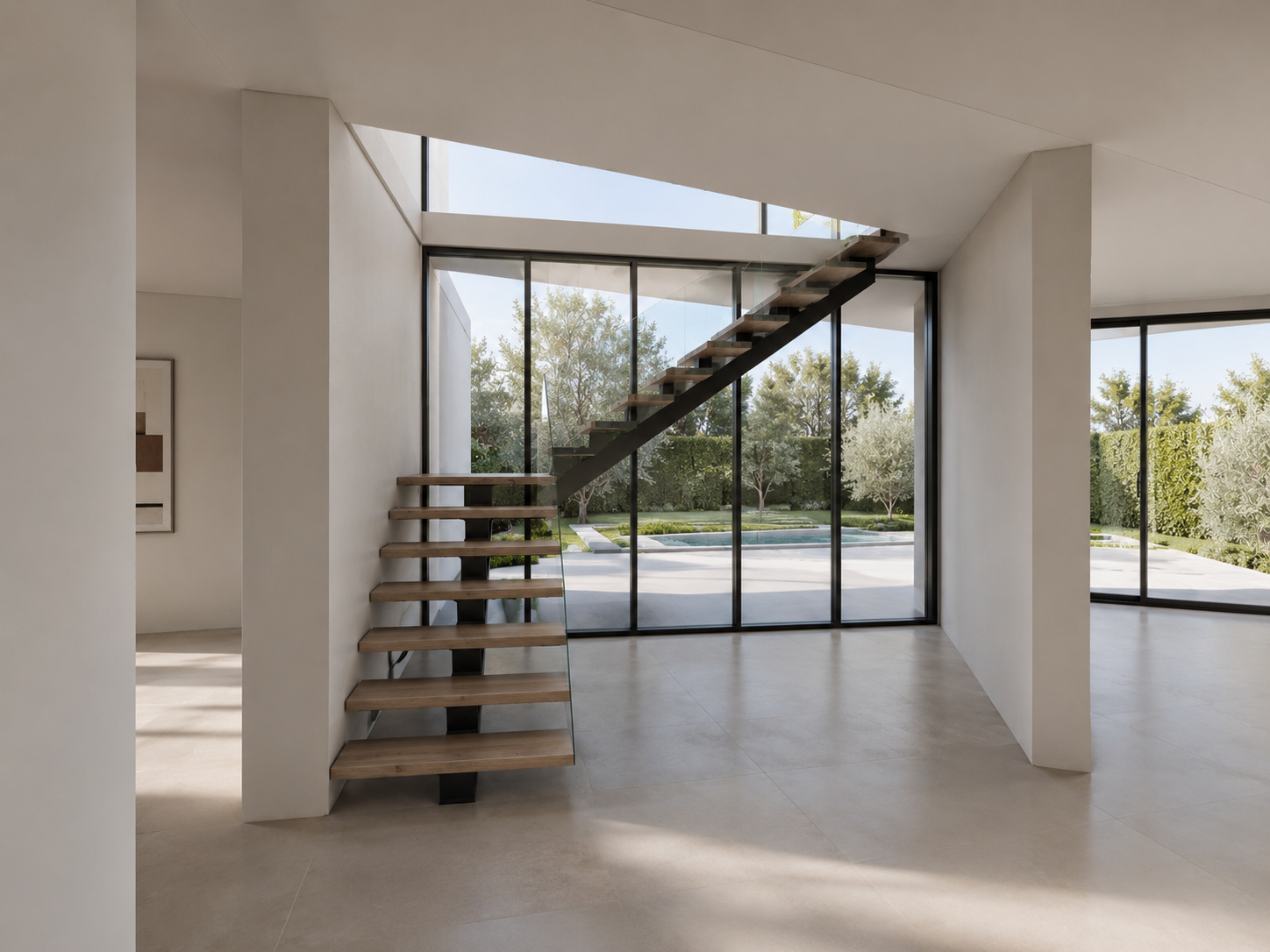 Entrance hall — stair core and double-height glazing facing the garden
